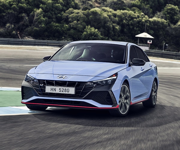 Front view of a blue 2022 Elantra N on a racetrack