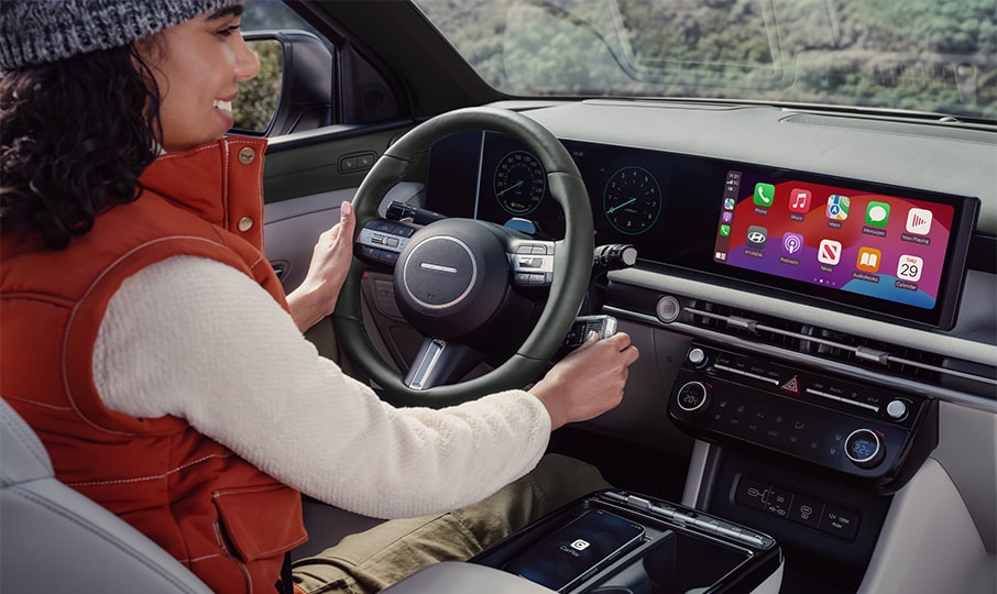 Interior view of Hyundai TUCSON with woman sitting in driver’s seat