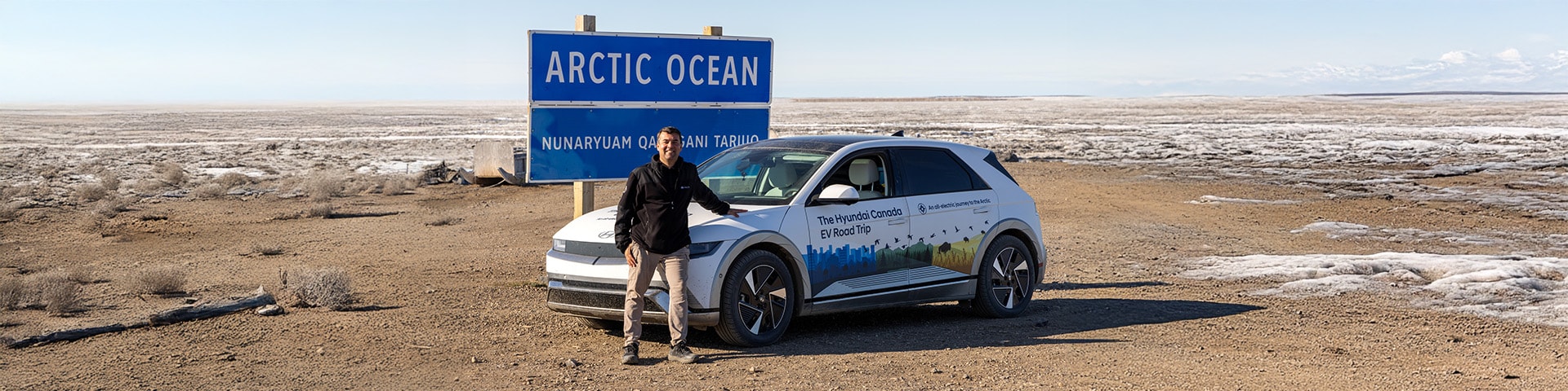 Patrick Nadeau poses with custom-wrapped Hyundai IONIQ 5 in front of Arctic Ocean sign