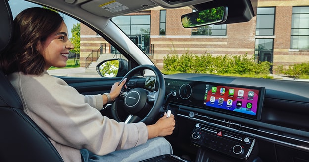 Interior view of Hyundai TUCSON with woman sitting in driver’s seat