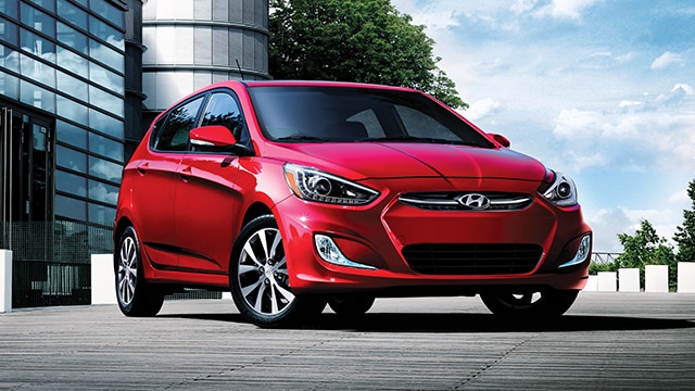 The exterior view in front of the Hyundai Accent compact black hatchback car with five doors