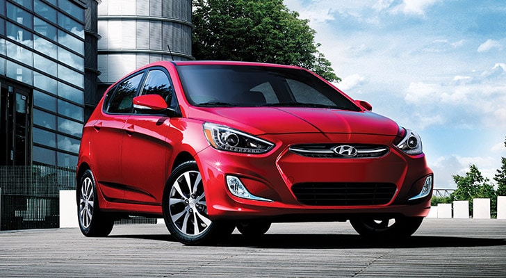 The exterior view in front of the Hyundai Accent compact black hatchback car with five doors