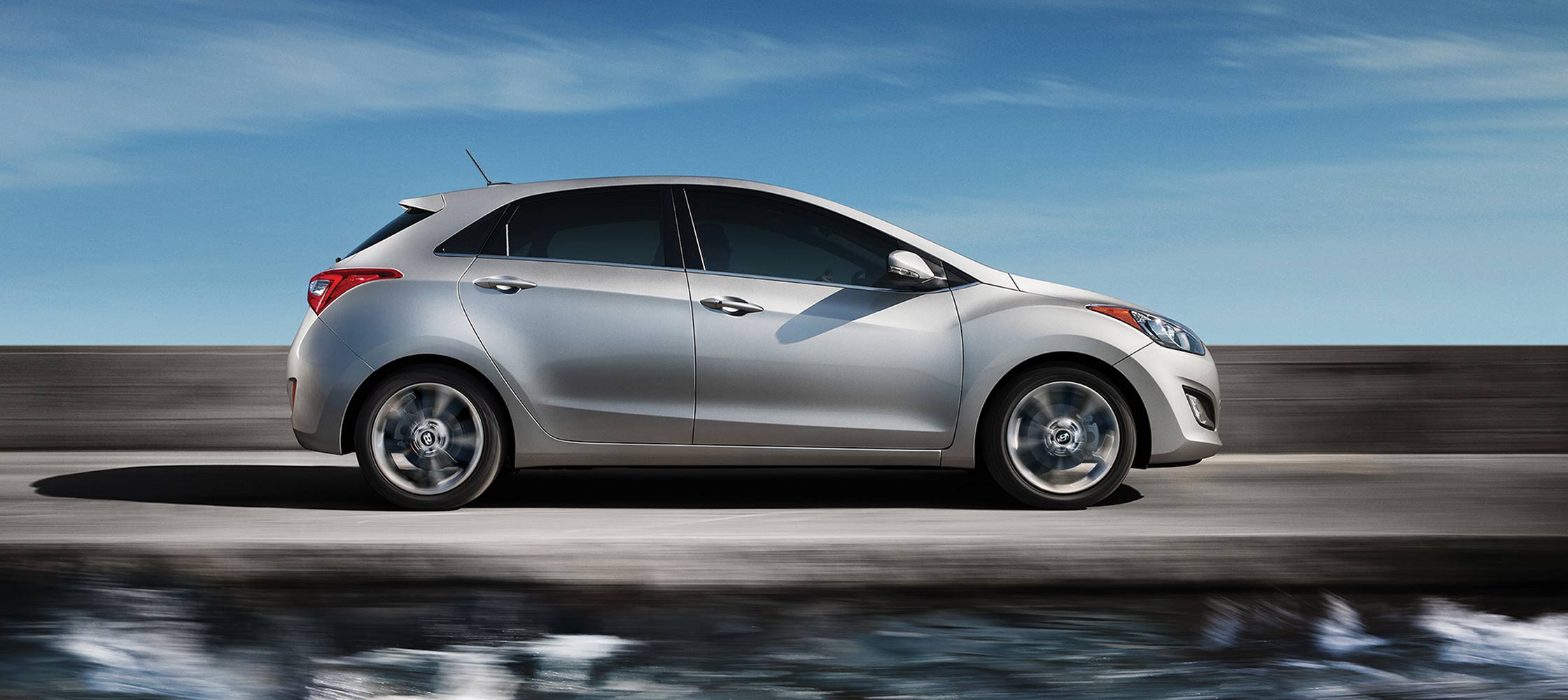 Exterior action photo of silver Hyundai Elantra GT four door compact car