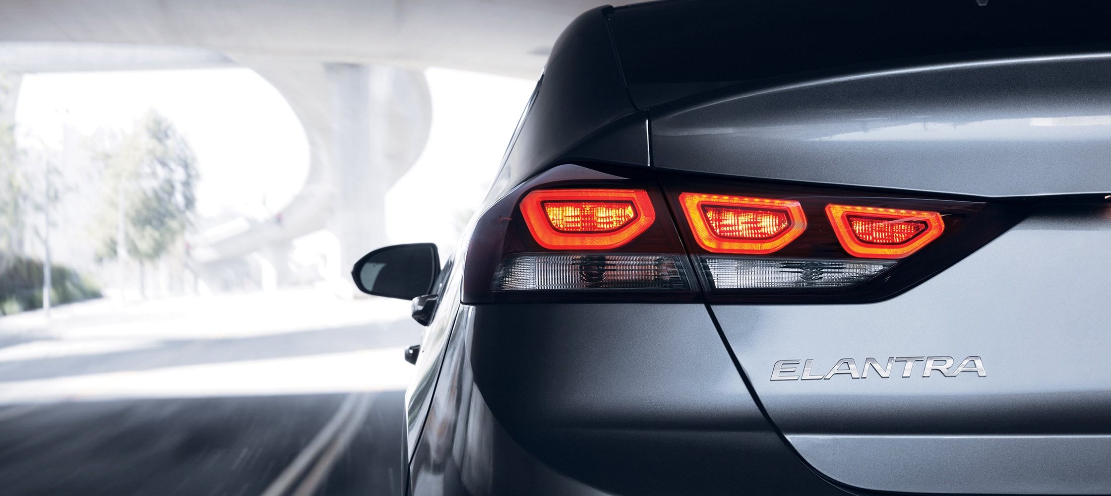 Exterior back photo of grey Hyundai Elantra V3 2018 sleek flashing tail lights