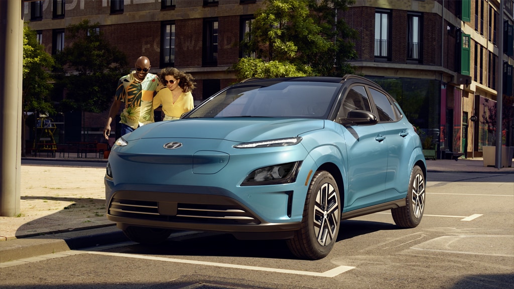 Front exterior view of a parked 2022 Kona Electric in surfy blue