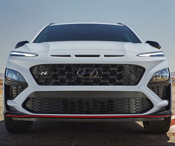 N front fascia with unique red front accents and mesh grille with N emblem on the 2022 KONA N in white