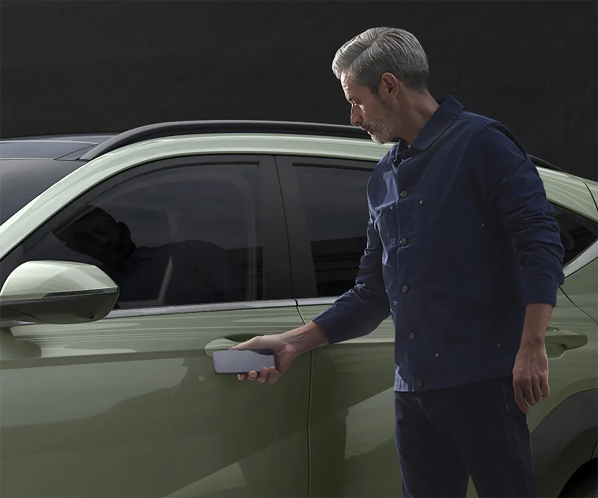 A person using Digital Key to unlock a 2027 Hyundai Kona with a smartphone
