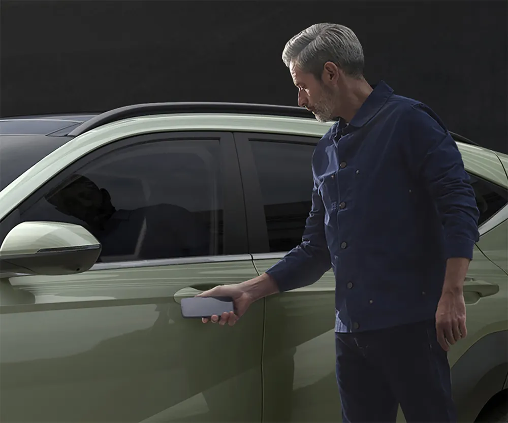 A person using Digital Key to unlock a 2027 Hyundai Kona with a smartphone