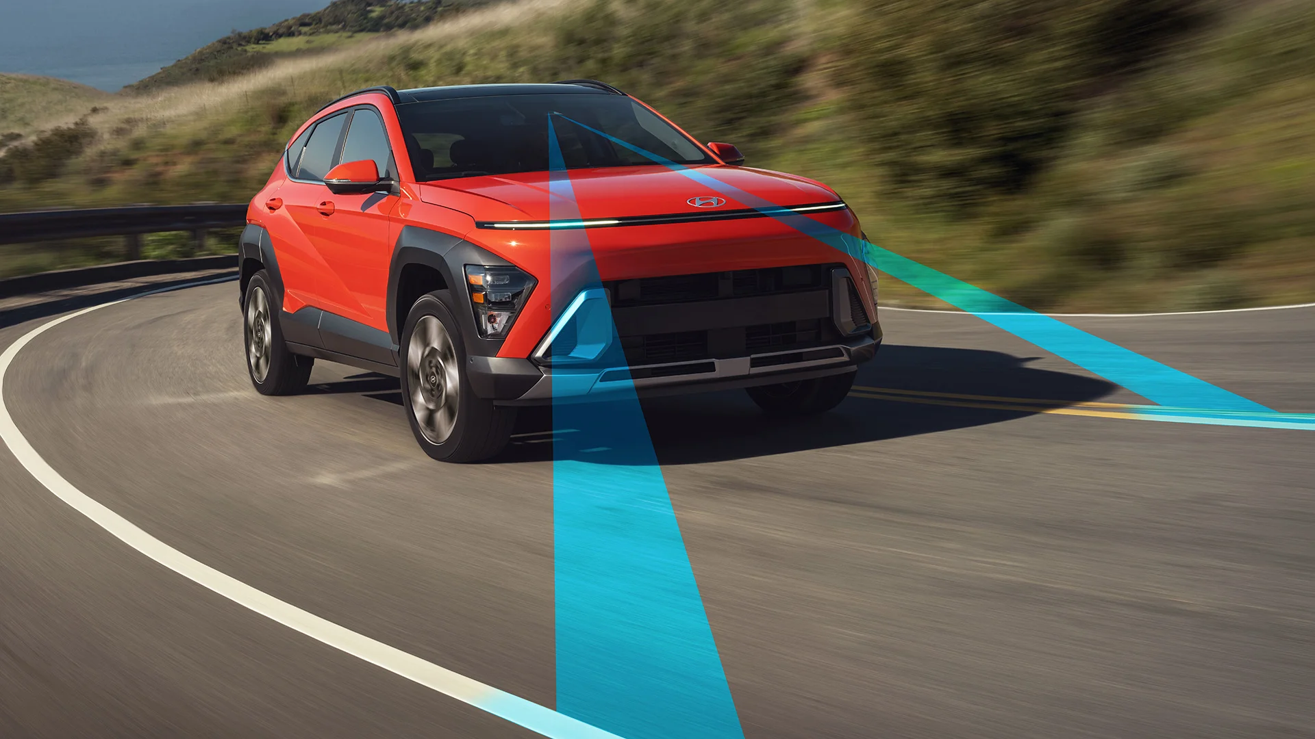 A 2027 Hyundai Kona drives along a road using its standard Lane Keeping Assist